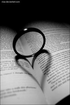 a black and white photo of a book with a magnifying glass on it