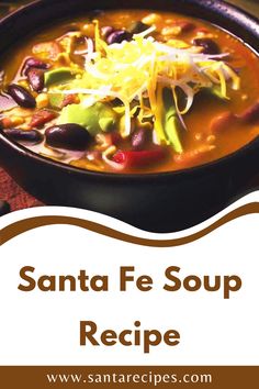 a bowl of santa fe soup with beans, cheese and other ingredients in it on a table