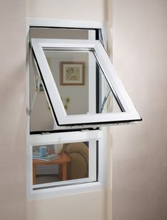 an open window with a white frame on the wall