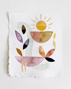 a piece of paper that has been painted with watercolors and is hanging on the wall