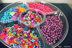 the tray is filled with different colored beads