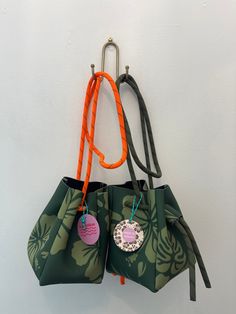 Add a touch of fun to your look with our LAS OLITAS Neo Bucket pouch bag! This small crossbody bucket bag is made from printed neoprene, giving it a unique and playful look. The contrast color nylon web strap adds a pop of color and extra durability for all your adventures. (Trust us, it'll be your new go-to bag!) small crossbody bucket bag printed neoprene contrast color nylon web strap Gift Green Bucket Bag With Removable Pouch, Green Bucket Bag With Removable Pouch As Gift, Green Bucket Bag With Removable Pouch For Gift, Green Bucket Bag With Removable Pouch, Vintage Everyday Bucket Bag With Removable Pouch, Vintage Pouch Bucket Bag For Travel, Modern Bucket Bag With Zipper Closure For On-the-go, Vintage Pouch Bucket Bag With Adjustable Strap, On-the-go Crossbody Bucket Bag With Removable Pouch