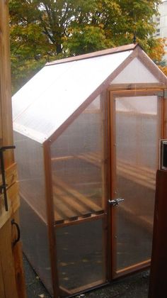 a small greenhouse in the middle of a yard