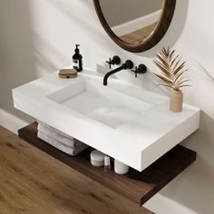 a bathroom sink sitting under a mirror next to a wooden counter top with soap dispensers on it