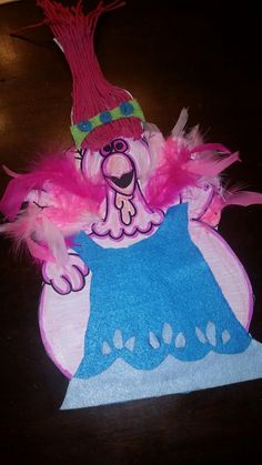 a paper plate with a pink and blue costume on it