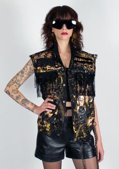 Custom punk rock vest by David Dalrymple. Vintage Levi's black denim vest with metallic gold painted artwork. Black sequin fringe detail, and mesh applique. Crystal embellishments and studs. Removable heavyweight wallet chain with wallet. Hand made by the designer in New York City. Unisex: Men's Small / Women's Large Black Denim Vest, Patricia Field, Metallic Gold Paint, Fringe Vest, Crystal Embellishment, Wallet Chain, Vintage Levis, Denim Vest, Black Sequins