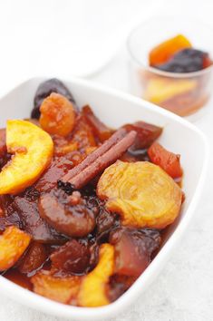 a white bowl filled with fruit and cinnamon