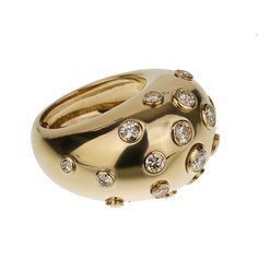 The Christian Dior Vintage Bombe Diamond 18k Yellow Gold Cocktail Ring is an exquisite piece that exemplifies the elegance and luxury synonymous with the Dior brand. This stunning cocktail ring is a perfect blend of classic design and sophisticated glamour, making it a must-have for any jewelry connoisseur. Crafted from 18k yellow gold, this ring features a bold and distinctive bombe design. The bombe style, characterized by its rounded, dome-like shape, creates a striking silhouette that is both eye-catching and timeless. The warm, rich hue of the yellow gold adds a touch of opulence, enhancing the overall allure of the piece. The surface of the ring is adorned with numerous bezel-set diamonds, each meticulously chosen for its brilliance and clarity. These diamonds are strategically place Luxury Dome Ring With 17 Jewels, Elegant White Gold Dome Ring With Brilliant Cut, Luxury White Gold Dome Ring For Formal Occasions, Luxury White Gold Dome Ring For Anniversary, Luxury Formal White Gold Dome Ring, Elegant White Gold Dome Ring With Single Cut Diamonds, Luxury Gold Diamond Evening Ring, Formal Polished Diamond Dome Ring, Classic Diamond White Rings For Evening