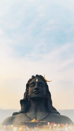 there is a large statue in front of the sky