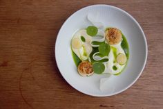 a white plate topped with food on top of a wooden table