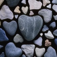 some kind of heart shaped rock on the side of a building with many other rocks in it