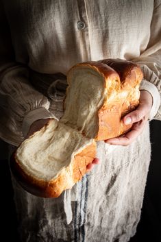 a person holding a loaf of bread in their hands