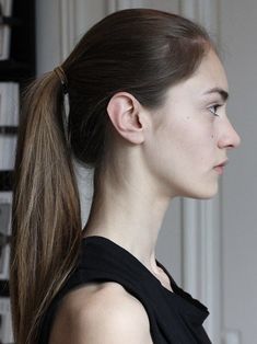 a woman with long hair in a ponytail