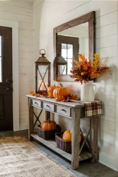 Wooden console table with fall decor including pumpkins, leaves, and a plaid runner Entrance Table Fall Decor, Cozy Fall Decor Ideas, Fall Hallway Decor, Entryway Table Fall Decor, Entryway Fall Decor Ideas, Fall Table Runner Decor, Console Table Fall Decor, Fall Entry Way Table Decor