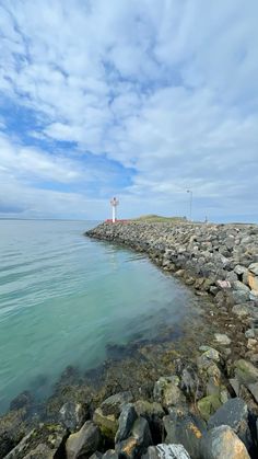 there is a light house on the rocky shore