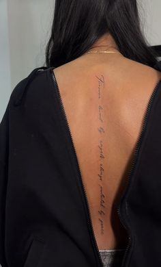 the back of a woman's neck with writing on it