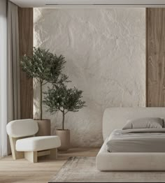 a white bed sitting next to a tall plant in a room with wooden floors and walls