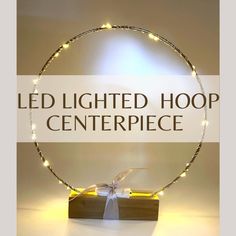 a lighted hoop with the words led lighted hoop centerpiece in front of it