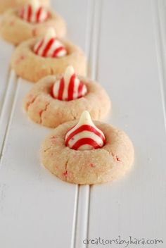 several cookies with candy canes on them are lined up in a row, ready to be eaten