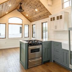 a kitchen with an oven, stove and cabinets in it