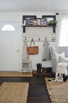 a room with a bench, chair and coat rack