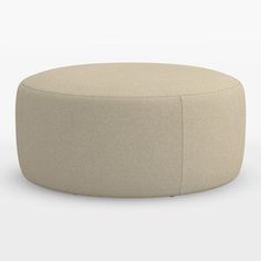 a round ottoman sitting on top of a white floor