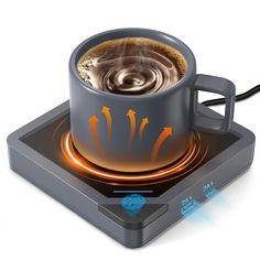 a coffee cup with steam rising out of it on top of an electronic device,