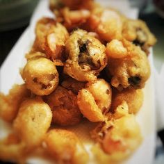 some fried food is sitting on a white paper towel and it's ready to be eaten