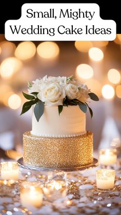 White one-tier wedding cake wrapped in gold sparkles, adding a touch of elegance and simplicity to the celebration. Simple Two Tiered Wedding Cakes, Simple Wedding Cake White And Gold, Small Wedding Cake Ideas Elegant Gold, White And Gold Cake Simple One Tier, Simple Tiered Wedding Cake, Simple White Two Tier Cake, Small Simple Wedding Cake 1 Tier, Simple Wedding Cake Small One Tier Fall, Wedding Cake No Flowers