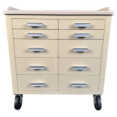 a white cabinet with many drawers on wheels