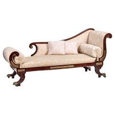 an ornately decorated chaise lounge with pillows on it's back and arms