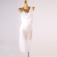 a woman's white dress on a mannequin