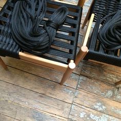 two chairs made out of wood and rope sitting on top of a wooden floor next to each other