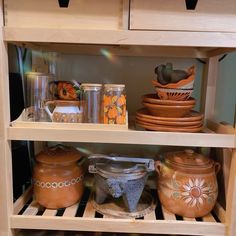 the shelves are filled with pots and pans