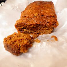 two pieces of meatloaf sitting on top of parchment paper next to each other