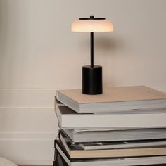 a stack of books with a lamp on top