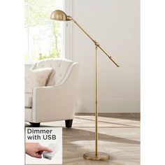 the dimmer with usb floor lamp is on display in front of a couch