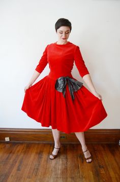 "Description: A soft cotton velvet red dress with a huge silver bow on the hip. Invisible metal zipper up the back! Measurements of garment, allow space for fit. Shoulder to Shoulder: 15.5\" Shoulder to Waist: 18.5\" Bust: 38\" Waist: 30\" Hips: Open Length: 43\" I take my measurements flat, and double for circumference. Tag: No tag Fabric: Cotton velvet Condition: Great shape, looks like dress has gone through some alterations, a few seams let out, and there is a large piece of fabric attached