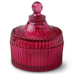 a red glass jar with a lid