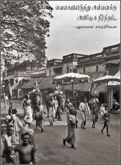 an old black and white photo of people walking down the street