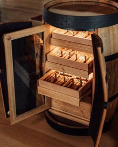 a wooden barrel filled with lots of different types of bread in it's opening