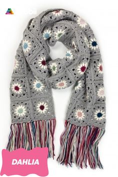 a crocheted scarf with fringes and flowers on the ends is shown in grey