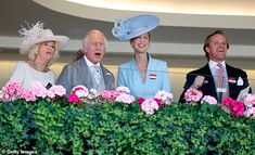 the queen and prince of england are surrounded by their family members as they look on