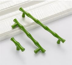 three green bamboo sticks sitting next to each other