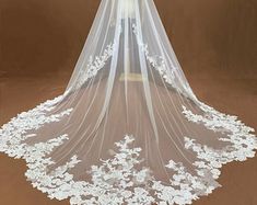 a wedding veil with white flowers on it