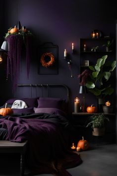 a bedroom decorated in purple and black with candles on the wall, pumpkins and other decorations