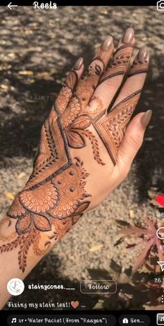 the hand is decorated with henna and flowers