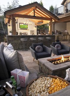 an outdoor patio with seating and fire pit