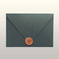 an envelope with a wax stamp and a rose on the front is shown in this image