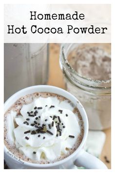 homemade hot cocoa powder in a mug with whipped cream and chocolate sprinkles